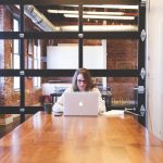 woman sitting at computer in a conference room