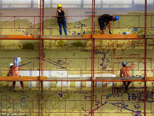 Four people on scaffolding