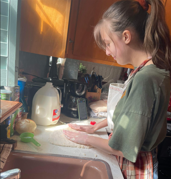 A child making dough in a kitchen

