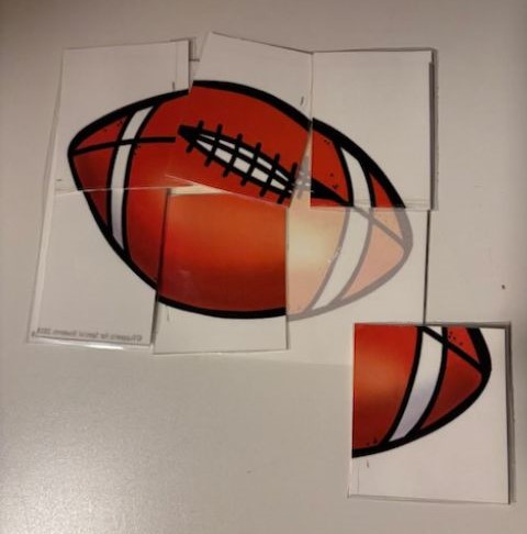 A partially completed football puzzle on a table