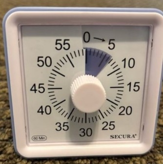A white square timer with a white dial