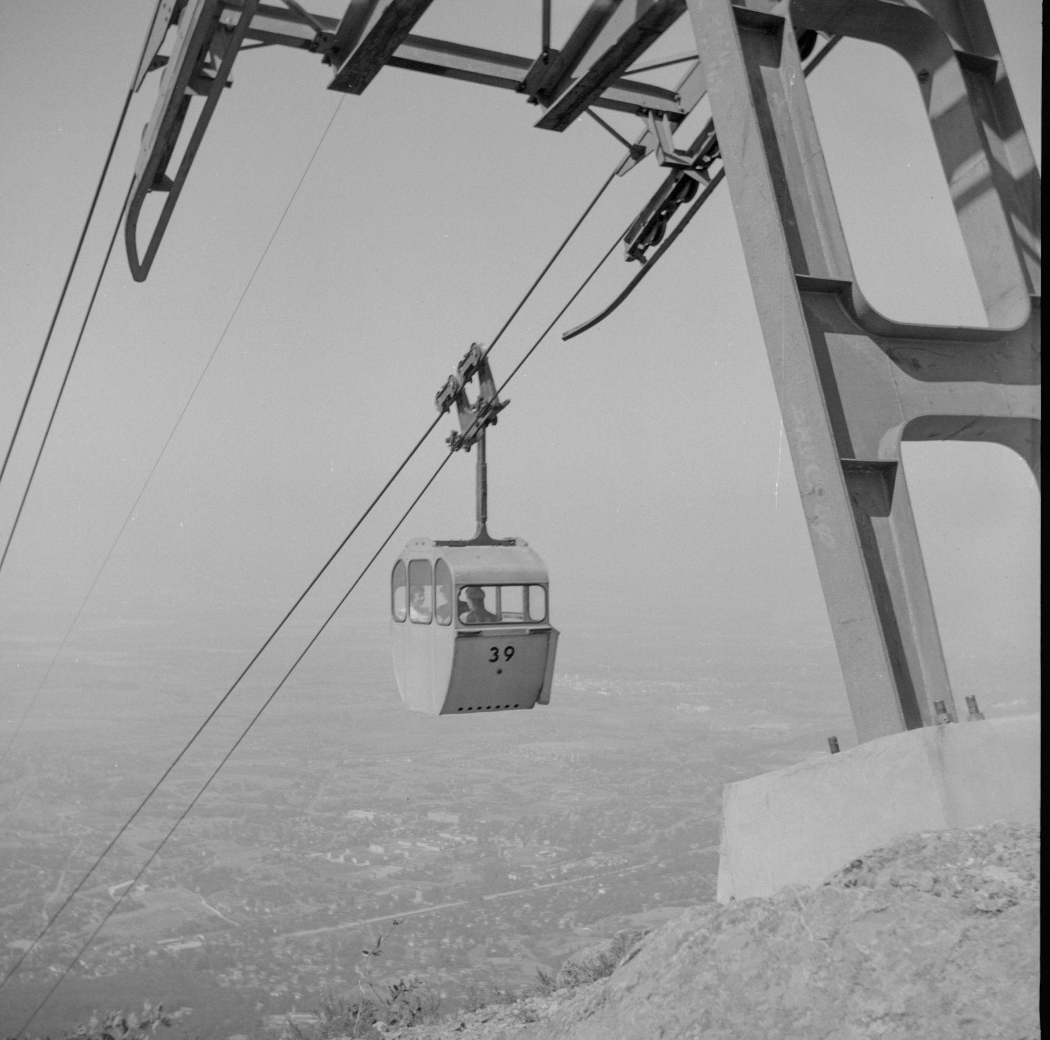 Cable car 39 suspended above a landscape.