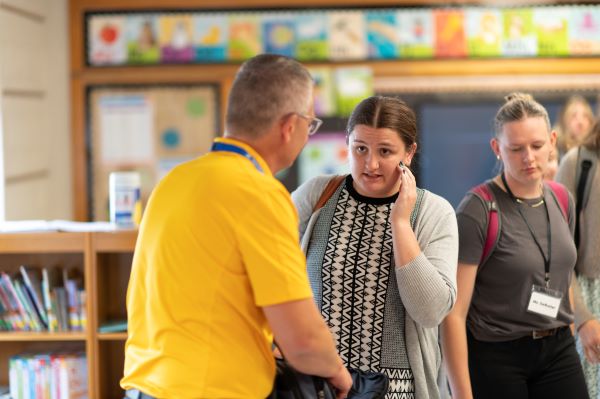 A teacher talks to a student after class.