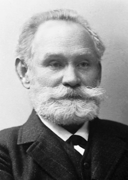 Photo of Ivan Pavlov. He has a white mustache and beard and is wearing a suit.