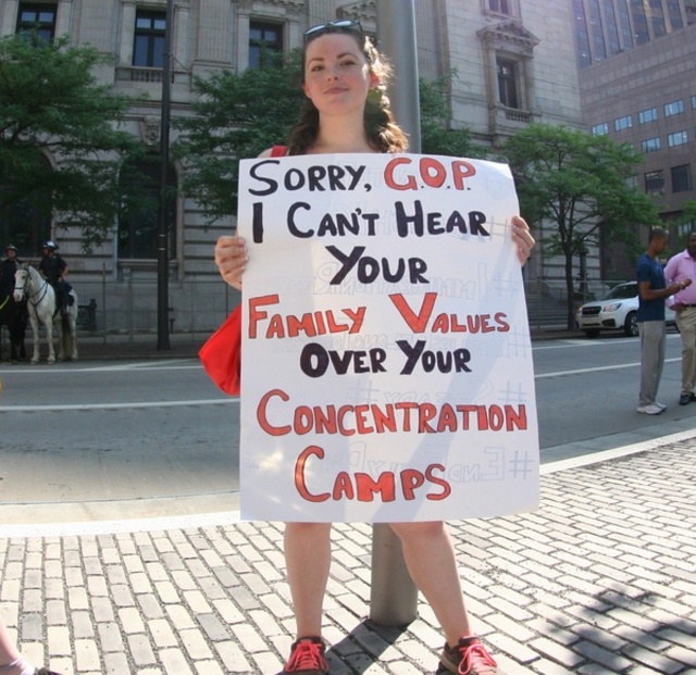 An activist holds a sign protesting the separations of families at the border