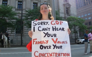 An activist holds a sign protesting the separations of families at the border