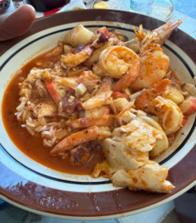 A bowl of Arroz a la tumbada, a rice and seafood dish