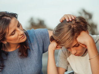 A mother comforts her son